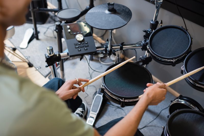 Cropped,View,Of,African,American,Customer,Playing,Electronic,Drums,In