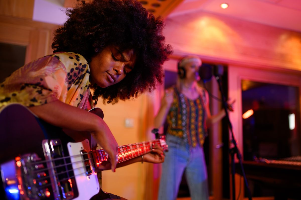 Portrait,Of,A,Hispanic,Woman,With,Afro,Hair,Playing,An